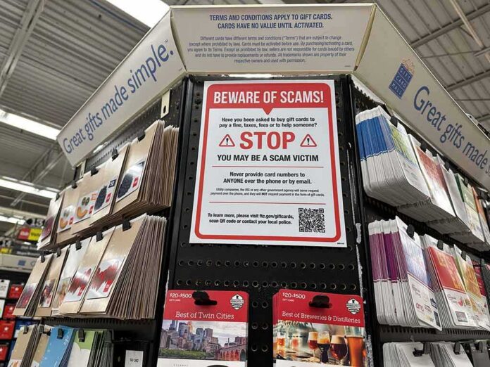 shutterstock_2230354941 Gift card display with scam warning sign