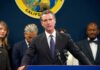 Gavin Newsom speaks at a podium with microphones during a press conference