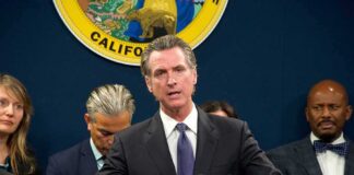 California Prepares for a Wave of New Laws Gavin Newsom speaks at a podium with microphones during a press conference