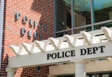 Police department entrance with pergola and brick wall