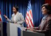 Terrorism Allegations Shake Senate Race Two women at podiums during a debate with U.S. flags behind them