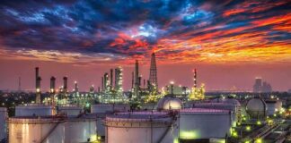 U.S. Offers 17 Million Barrels From Oil Reserve Oil refinery with storage tanks at sunset