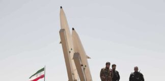 Trump Makes Bold Claims on Iran and Ukraine Soldiers stand beside large missiles at an outdoor display