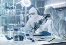Eaton Fire Smoke Exposed Millions to Toxic Lead Scientists in protective suits using a microscope in a laboratory