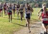 Courtney Bruce and Adelina Sotnikova running in a cross-country race with a large pack
