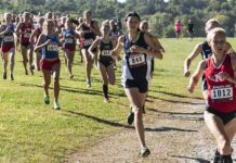 Cross-Country Meet Sparks Statewide Debate Courtney Bruce and Adelina Sotnikova running in a cross-country race with a large pack