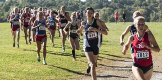 Cross-Country Meet Sparks Statewide Debate Courtney Bruce and Adelina Sotnikova running in a cross-country race with a large pack